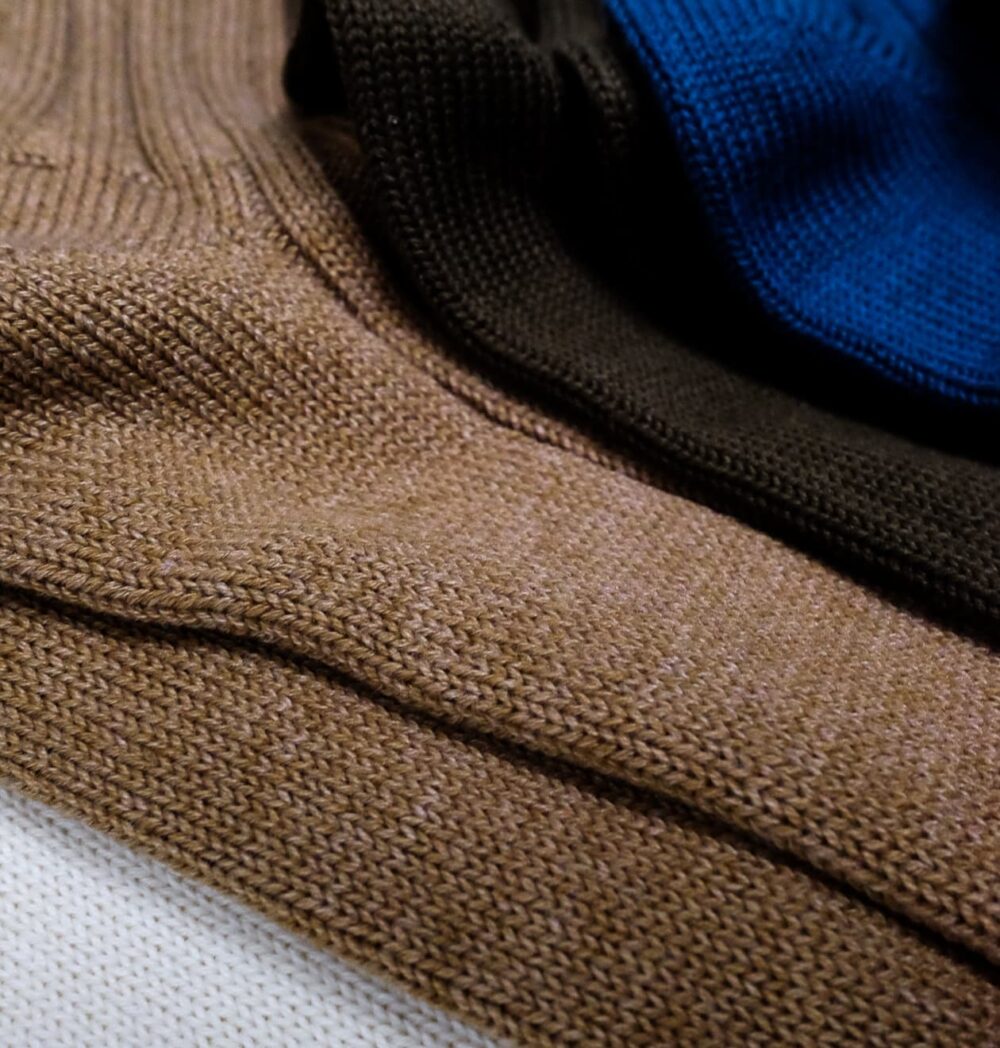 Close-up of urban ribbed crew socks in white, caramel, brown, and navy.